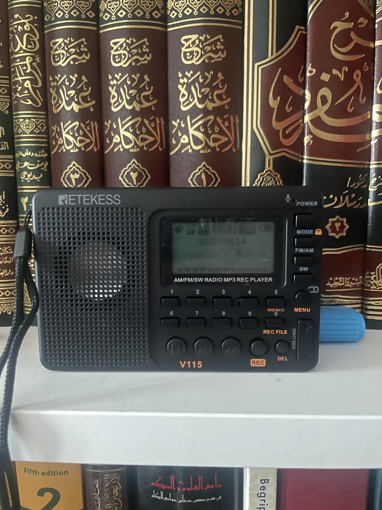 Rayan E’s Radio beside a shelf of books